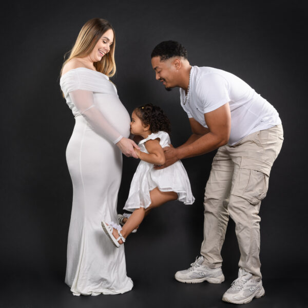 portrait de femme enceinte avec le papa et une petite fille qui embrasse le ventre de sa maman