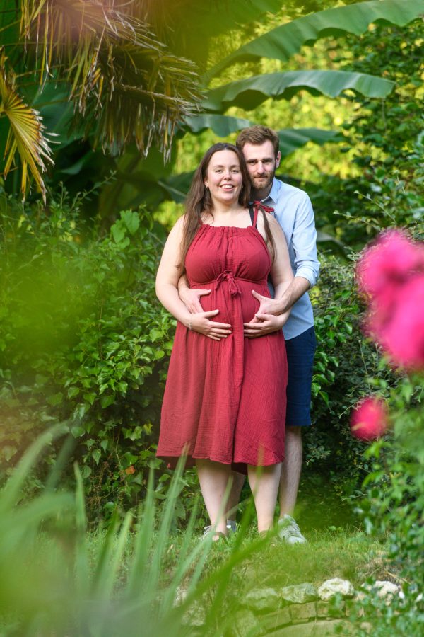 portrait femme enceinte avec papa en extérieur avec des fleurs